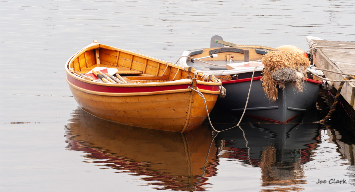 Multiple small racing sailboats round the mark in the 2025 SailPac Regatta