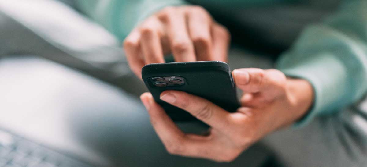 A person using a mobile phone indoors