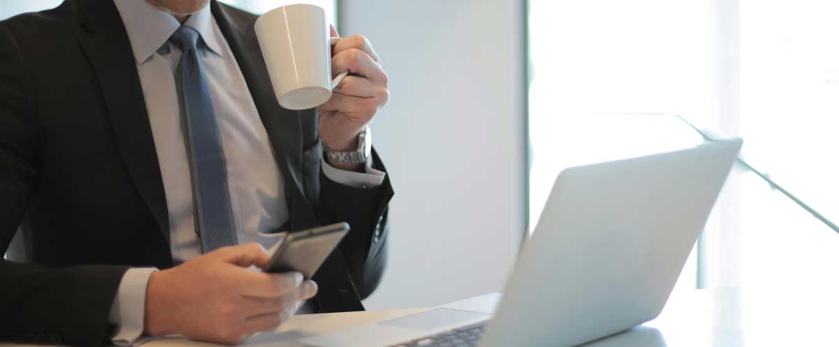 Business professional working on a laptop and phone